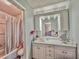Bright bathroom features a vanity with a sink and a full shower and tub enclosure at 4359 Idlewood Ln, Tucker, GA 30084