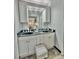 Double vanity bathroom with dark countertop and white cabinets at 4359 Idlewood Ln, Tucker, GA 30084