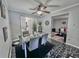 Modern dining room with a glass table, marble floors, ceiling fan, and sleek decor at 4359 Idlewood Ln, Tucker, GA 30084
