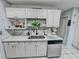 White kitchen with stainless steel appliances and granite countertop at 4359 Idlewood Ln, Tucker, GA 30084