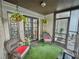 Charming covered patio with wicker seating, hanging plants and artifical grass at 4359 Idlewood Ln, Tucker, GA 30084