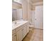 Bathroom with white vanity, tub, and tile floors at 1850 Cotillion Dr # 3221, Dunwoody, GA 30338