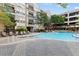 Resort-style pool with lounge chairs and a pergola at 1850 Cotillion Dr # 3221, Dunwoody, GA 30338