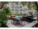 Community pool area with brick patio, seating, and grill at 1850 Cotillion Dr # 3221, Dunwoody, GA 30338