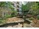 Peaceful water feature with footbridge and lush landscaping at 1850 Cotillion Dr # 3221, Dunwoody, GA 30338