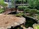 Serene water feature with a charming wooden bridge and lush greenery at 1850 Cotillion Dr # 3221, Dunwoody, GA 30338