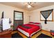 Bedroom with a red bedspread and hardwood floors at 3208 Edgemont Way, Decatur, GA 30032