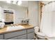 Bathroom with granite countertop, white sink, and shower with curtain at 980 Fenimore Cir, Sandy Springs, GA 30350