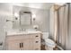 Bright bathroom featuring a modern vanity with white marble countertop and a shower with a neutral-toned curtain at 980 Fenimore Cir, Sandy Springs, GA 30350