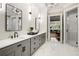 Stylish bathroom with double vanity, marble-look tile, and glass-enclosed shower at 980 Fenimore Cir, Sandy Springs, GA 30350