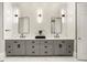 Modern bathroom with marble-look tile, dual sinks, and sleek fixtures at 980 Fenimore Cir, Sandy Springs, GA 30350