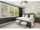 Bedroom features modern lighting, black accent wall, and a large window at 980 Fenimore Cir, Sandy Springs, GA 30350