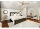 This bedroom boasts a decorative rug, a ceiling fan, and a king bed with plush pillows, creating a cozy, inviting space at 980 Fenimore Cir, Sandy Springs, GA 30350