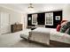 Modern bedroom with black accent wall, natural light, and stylish furnishings at 980 Fenimore Cir, Sandy Springs, GA 30350