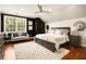 Relaxing bedroom featuring a large bed, a ceiling fan, and plenty of natural light, perfect for restful sleep and relaxation at 980 Fenimore Cir, Sandy Springs, GA 30350