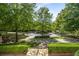 Scenic circular driveway surrounded by lush greenery and manicured hedges and stone steps at 980 Fenimore Cir, Sandy Springs, GA 30350