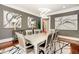Formal dining room featuring modern lighting, elegant artwork, and seating for eight at 980 Fenimore Cir, Sandy Springs, GA 30350