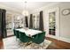 Formal dining room featuring modern lighting, dark curtains, and a door to the outside patio at 980 Fenimore Cir, Sandy Springs, GA 30350