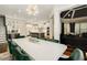 The dining room features modern lighting, dark green chairs, and an open floor plan at 980 Fenimore Cir, Sandy Springs, GA 30350
