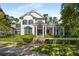 Elegant two-story home with black-framed windows and manicured front lawn and stairway to the front door at 980 Fenimore Cir, Sandy Springs, GA 30350