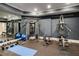 Spacious home gym with a full mirror wall, multi-station equipment, and rubber flooring at 980 Fenimore Cir, Sandy Springs, GA 30350