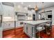 Bright kitchen with a large marble island, stainless steel appliances, and custom range hood at 980 Fenimore Cir, Sandy Springs, GA 30350