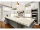 Luxury kitchen boasts large central island, stainless steel appliances, and custom cabinetry at 980 Fenimore Cir, Sandy Springs, GA 30350
