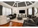 Bright living room featuring a coffered ceiling, fireplace and large comfortable seating at 980 Fenimore Cir, Sandy Springs, GA 30350