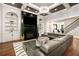 Modern living room featuring fireplace, built-in shelving, and staircase to the second floor at 980 Fenimore Cir, Sandy Springs, GA 30350
