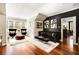 Charming living room with hardwood floors, a plush rug, and stylish decor, offering a cozy and inviting atmosphere at 980 Fenimore Cir, Sandy Springs, GA 30350
