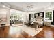 Spacious main bedroom with hardwood floors, large windows, and elegant gray and silver furnishings at 980 Fenimore Cir, Sandy Springs, GA 30350