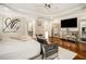 Bright bedroom with hardwood floors, mirrored furniture, and an adjoining bathroom at 980 Fenimore Cir, Sandy Springs, GA 30350