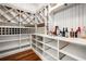 Custom pantry featuring wine storage, shelving and wooden floor at 980 Fenimore Cir, Sandy Springs, GA 30350
