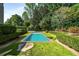 The backyard has a refreshing pool surrounded by manicured hedges and lush greenery for privacy at 980 Fenimore Cir, Sandy Springs, GA 30350