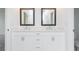 Bathroom features double sink vanity with white cabinets and framed mirrors at 332 Olmstead Way # 38, Alpharetta, GA 30022