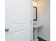 Modern powder room with pedestal sink and a framed mirror at 332 Olmstead Way # 38, Alpharetta, GA 30022