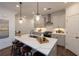 Modern kitchen with quartz countertops, stainless steel appliances, pendant lights, and bar stool seating at 332 Olmstead Way # 38, Alpharetta, GA 30022