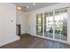 Bright living room with hardwood floors and sliding glass doors to the patio at 332 Olmstead Way # 38, Alpharetta, GA 30022