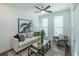 Cozy living room with stylish sofa, modern art, ceiling fan, and bright natural light at 332 Olmstead Way # 38, Alpharetta, GA 30022