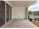 Spacious covered patio featuring brick flooring and views of the street at 332 Olmstead Way # 38, Alpharetta, GA 30022