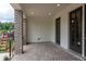 Covered patio with brick flooring, elegant trim, and access to outdoor spaces at 332 Olmstead Way # 38, Alpharetta, GA 30022