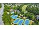 This aerial view shows a community with tennis courts, a pool, and lush green landscaping in a desirable neighborhood at 2423 Rosapenna Nw Ln, Kennesaw, GA 30152