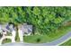 Aerial view showcasing the home's location with a large lot and close proximity to surrounding woods at 2423 Rosapenna Nw Ln, Kennesaw, GA 30152