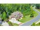Aerial view of a red brick home showcasing its expansive lot and surrounding trees at 2423 Rosapenna Nw Ln, Kennesaw, GA 30152