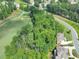 Golf course side lot with lush trees surrounding the luxury brick home at 2423 Rosapenna Nw Ln, Kennesaw, GA 30152