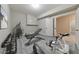 Basement gym with modern exercise equipment including weight rack, bench, elliptical machine, and wood plank flooring at 2423 Rosapenna Nw Ln, Kennesaw, GA 30152