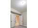 Basement area featuring gray plank flooring, neutral paint, and doorway leading to other finished spaces at 2423 Rosapenna Nw Ln, Kennesaw, GA 30152