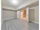 Spacious basement with gray wood flooring and open doorway to stairs leading to the upper level at 2423 Rosapenna Nw Ln, Kennesaw, GA 30152
