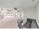 Large finished basement featuring recessed lighting, gray carpet, neutral paint, and a comfortable gray tufted sofa with ottoman at 2423 Rosapenna Nw Ln, Kennesaw, GA 30152