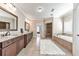 Luxurious bathroom with a double vanity, soaking tub, and separate shower with tile surround at 2423 Rosapenna Nw Ln, Kennesaw, GA 30152